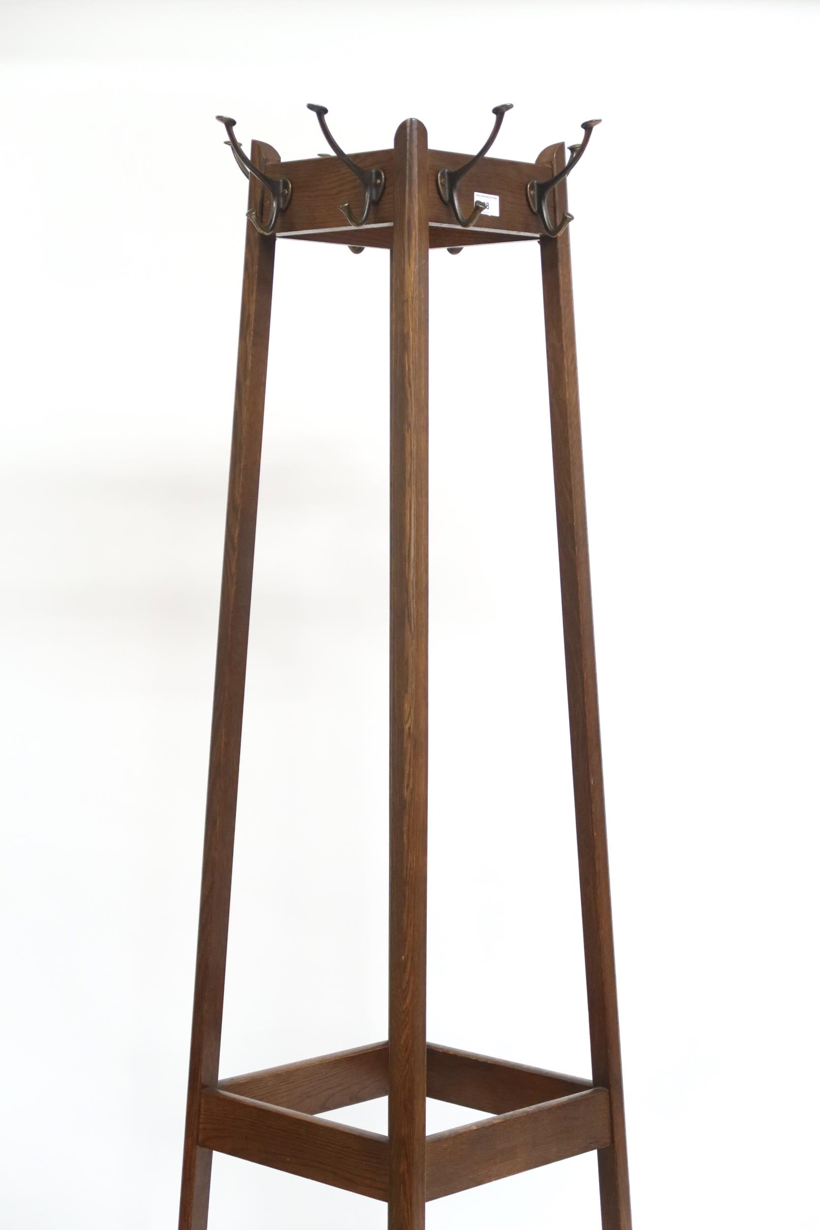 An early 20th century oak freestanding hat and coat stand with stylized metallic hooks to each side, - Image 3 of 3