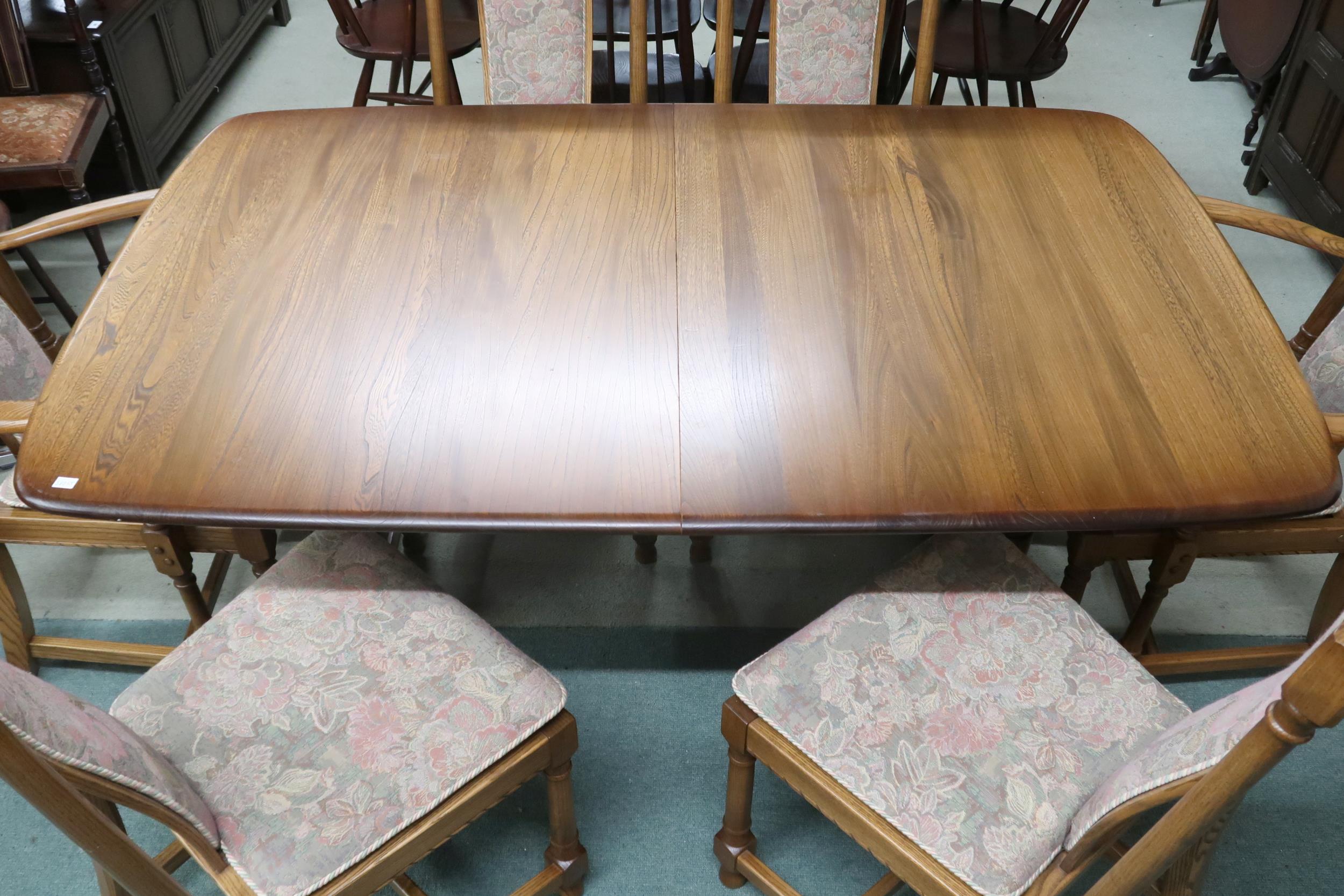 A 20th century Ercol elm and beech extending dining table and six chairs, table on trestle - Image 2 of 3