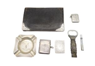 A silver ash tray, Birmingham, a silver vesta, another example, a silver match box, a silver money