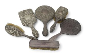 A collection of silver part dressing sets, a brush and mirror Birmingham 1915, another mirror by