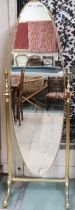 A 20th century brass framed cheval dressing table with reeded uprights capped on scrolled out