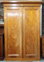 A Victorian two door wardrobe with moulded cornice over two panel front wardrobe doors concealing