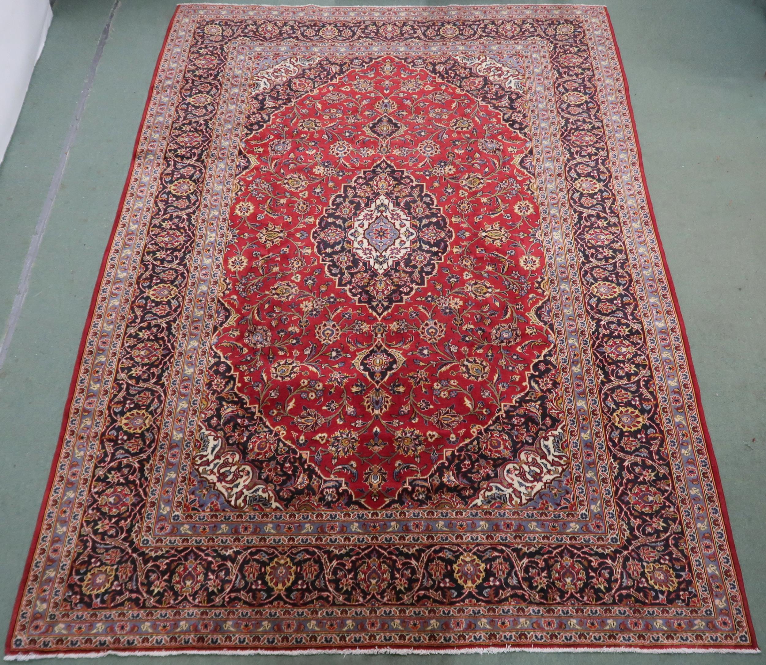 A RED GROUND KASHAN RUG  With dark blue and cream diamond central medallion and matching spandrels - Image 2 of 9