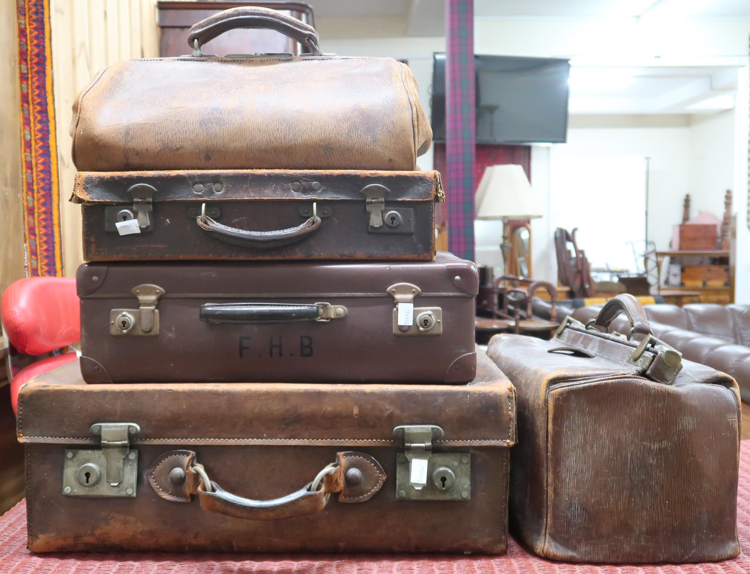 A mixed lot comprising three leather suitcases and two assorted Gladstone style bags (5) Condition