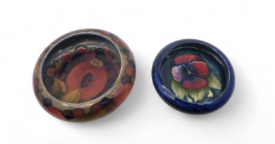 A William Moorcroft pomegranate pattern bowl, 13cm diameter, together with a Pansy pattern bowl