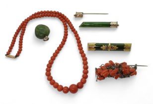 A string of coral beads, largest approx 9.6mm, with a coral brooch, two New Zealand green stone