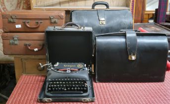 A lot comprising four assorted leather suitcases and a cased Remington typewriter (5) Condition