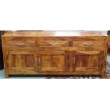 A contemporary mangowood sideboard with three drawers over three panel cabinet doors on square feet,