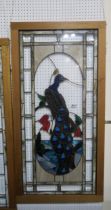 A large stained glass panel depicting a peacock, 61cm x 122cm Condition Report:Available upon