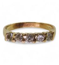 A bright yellow metal five stone diamond ring, set with estimated approx 0.50cts of brilliant cut