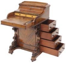 A Victorian walnut Davenport writing desk with concealed stationary compartment over pull out