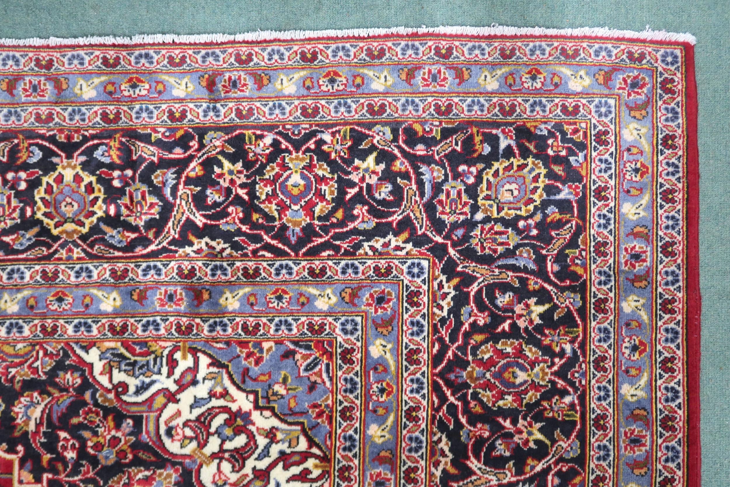 A RED GROUND KASHAN RUG  With dark blue and cream diamond central medallion and matching spandrels - Image 9 of 9