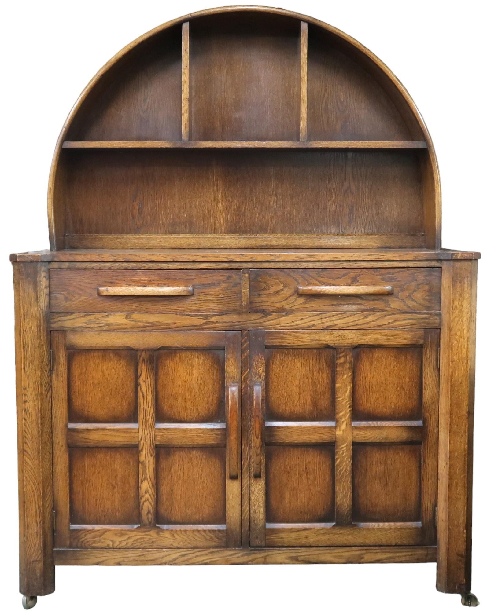 A 20th century oak sideboard with arched shelved back on base with pair of drawers over pair of