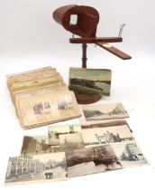 A late-Victorian "Triumph" stereoscopic slide viewer on stand, with a mixed selection of