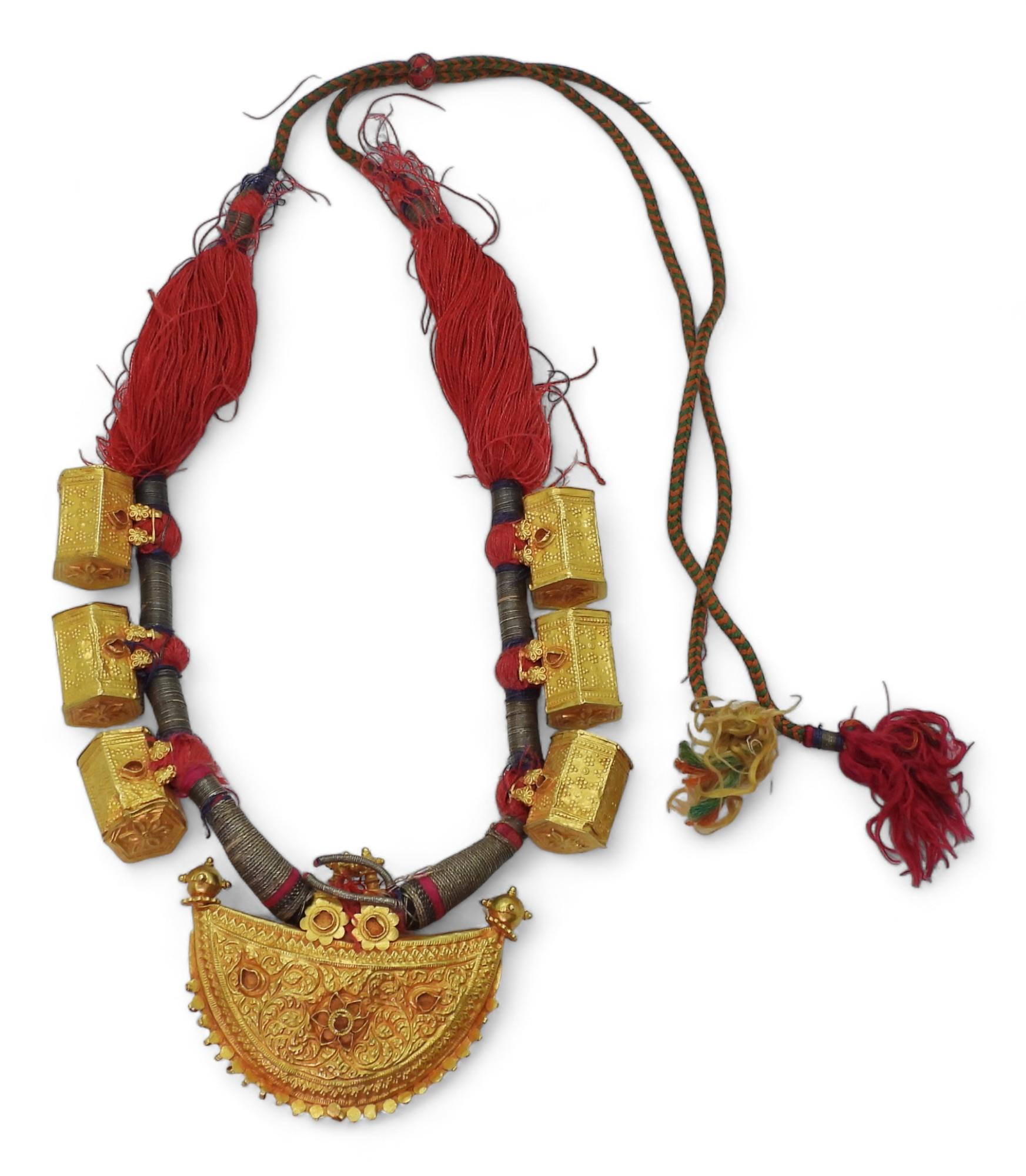 An antique Indian bridal necklace, in bright yellow metal the front half moon shaped pendant is