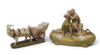 A Royal Dux centrepiece modelled as a couple drinking from a bowl, together with a goat pulling a