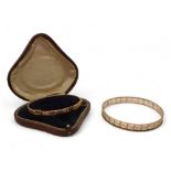 A 9ct upper arm bangle, inner diameter 7.2cm, together with a 9ct (af) buckle bangle, weight