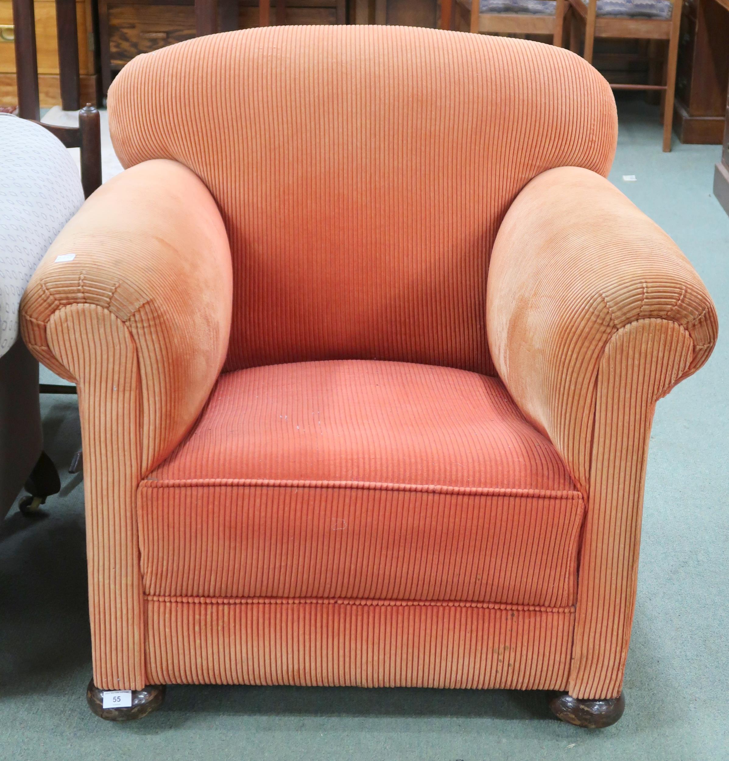 An early 20th century cord upholstery scroll arm chair on bun feet, 79cm high x 88cm wide x 93cm