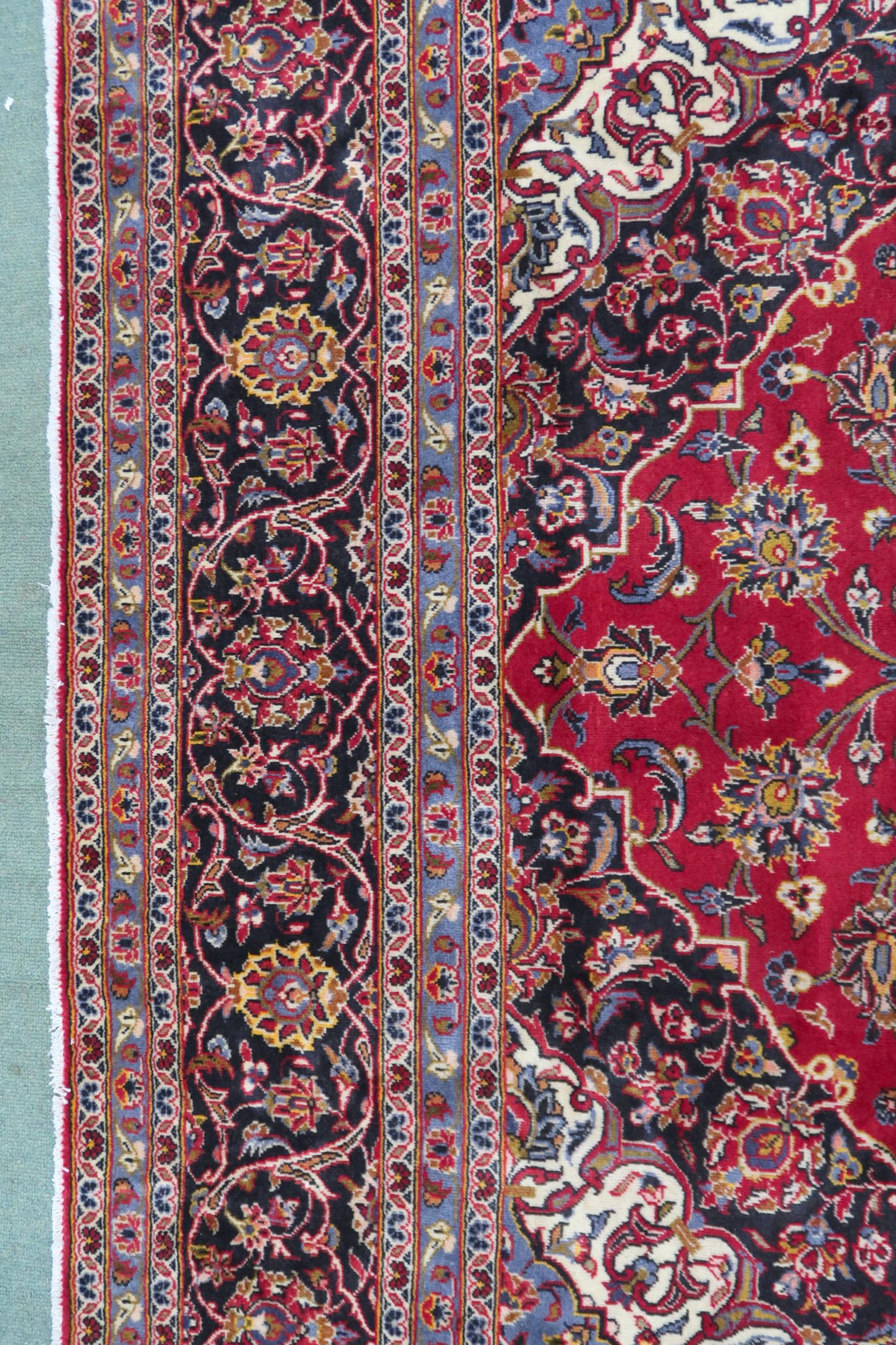 A RED GROUND KASHAN RUG  With dark blue and cream diamond central medallion and matching spandrels - Image 6 of 9
