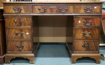 A 20th century mahogany pedestal writing desk with embossed skiver over central long drawer