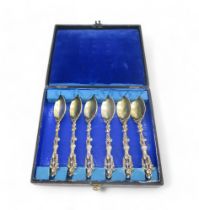 A set of cased continental silver gilt teaspoons, with figural terminals featuring cherubs, 172gms