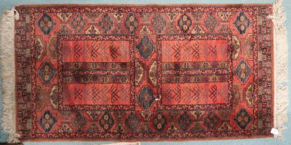 A red panelled ground Persian style rug with geometric borders, 164cm long x 84cm wide Condition