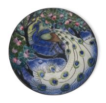 A continental pottery wall plate with tube line decoration of a peacock, 29.5cm diameter Condition