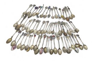 A collection of novelty silver and white metal spoons, including souvenir spoons, some with enamel