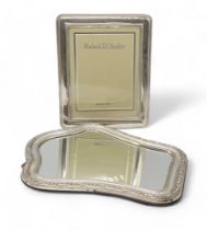 Two Italian silver photo frames, one of shaped form with a scrollwork border, another of rectangular