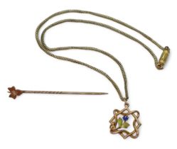 A 9ct Edwardian pendant with an enamelled flower set with a blue gem, on a vintage 39cm yellow metal