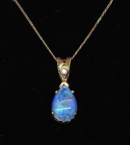 A 9ct gold black opal pendant with diamond accent, on a fine 9ct gold 46cm curb chain, weight 2.1gms