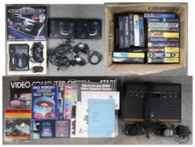 A boxed Sega Mega Drive 16-bit console, together with two further loose consoles, an assortment of