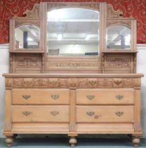 A 20th century pine mirrored back bank of drawers with foliate carved bevelled mirror back on base