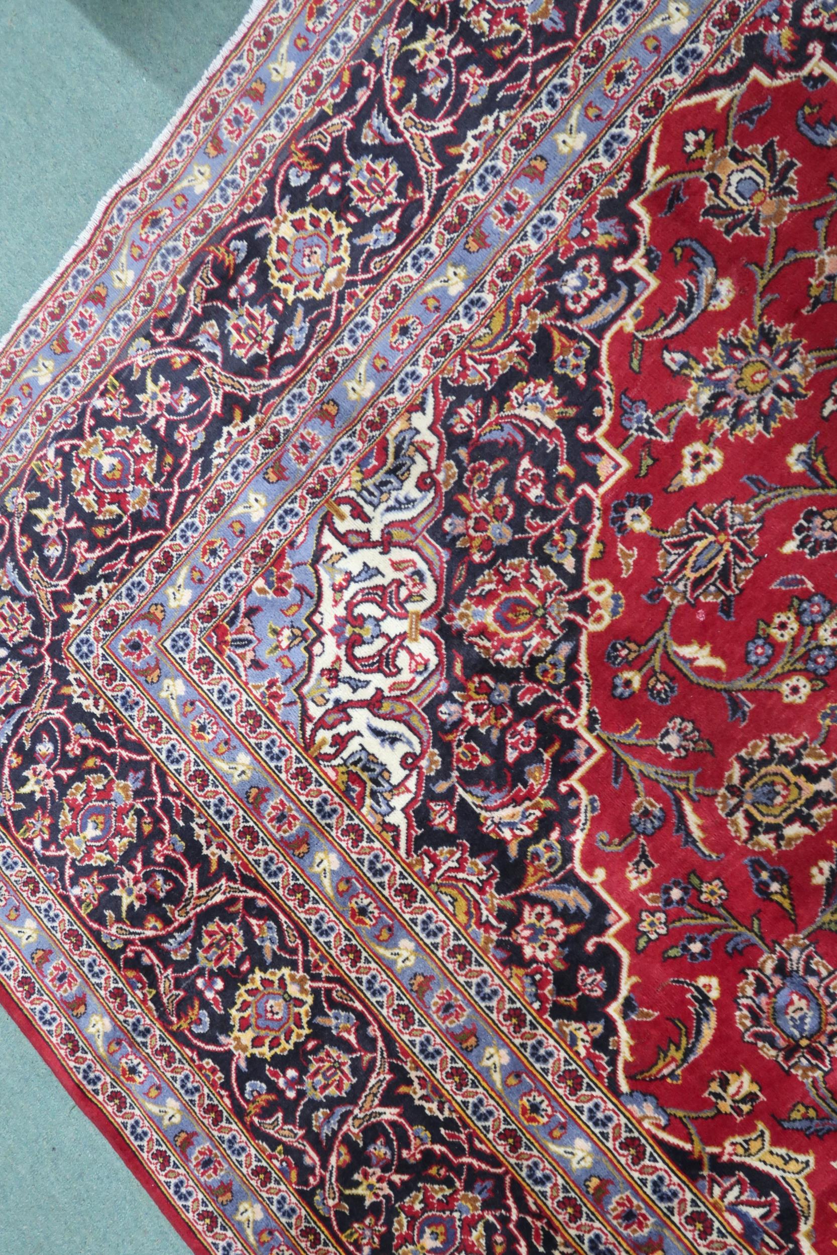 A RED GROUND KASHAN RUG  With dark blue and cream diamond central medallion and matching spandrels - Image 4 of 9