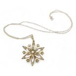 A 9ct gold pearl flower pendant with a 9ct gold rope chain, weight 3.9gms Condition Report:was a