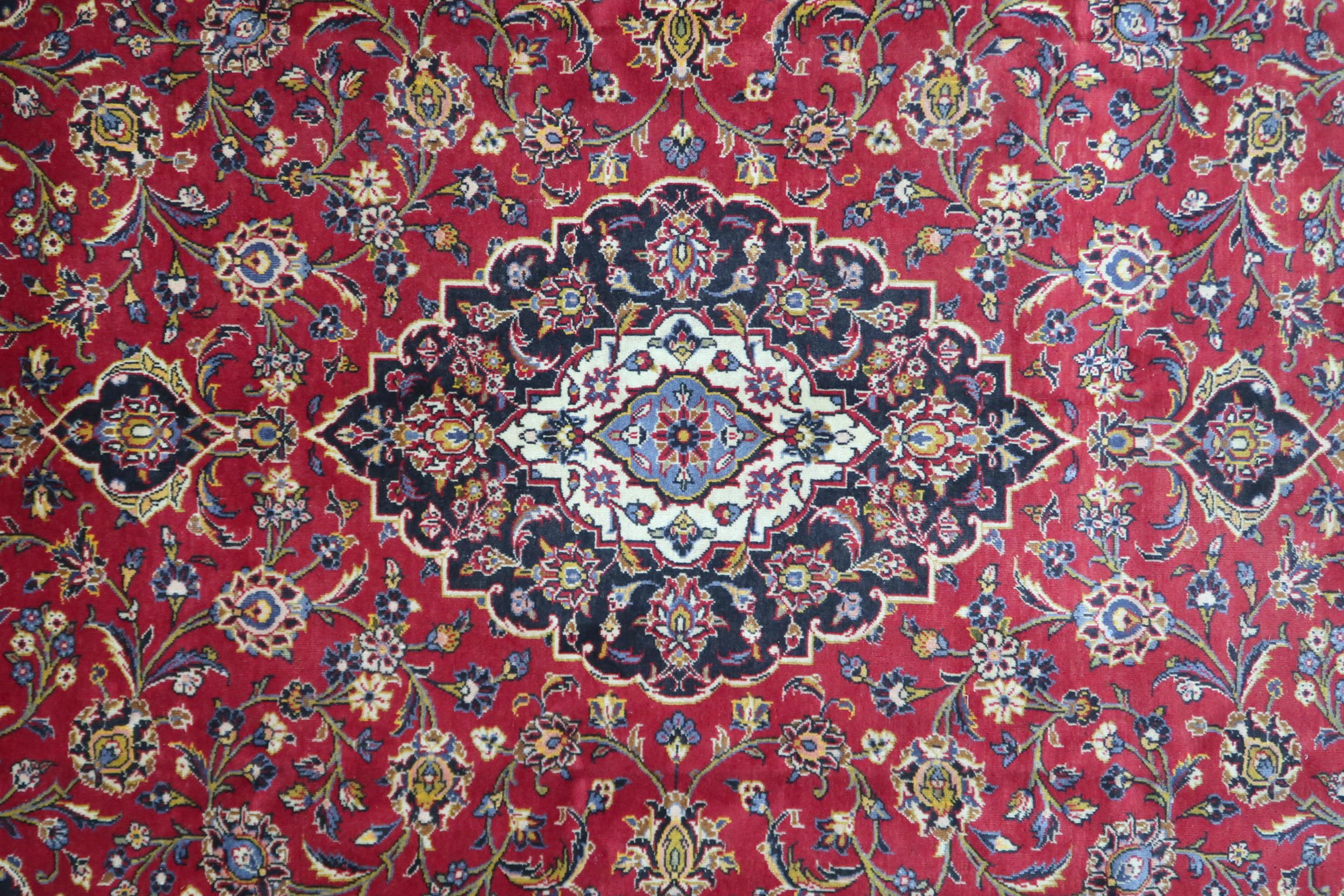 A RED GROUND KASHAN RUG  With dark blue and cream diamond central medallion and matching spandrels - Image 3 of 9