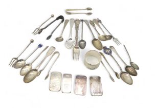 A collection of silver including silver ingots, silver flatware including Georgian spoons, forks,