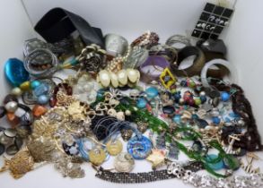 A large collection of costume jewellery to include skull rings, statement bangles and necklaces