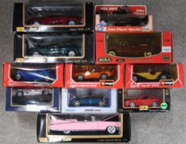 An assortment of boxed 1:18 and 1:24-scale diecast model vehicles, with makers t include Burago,