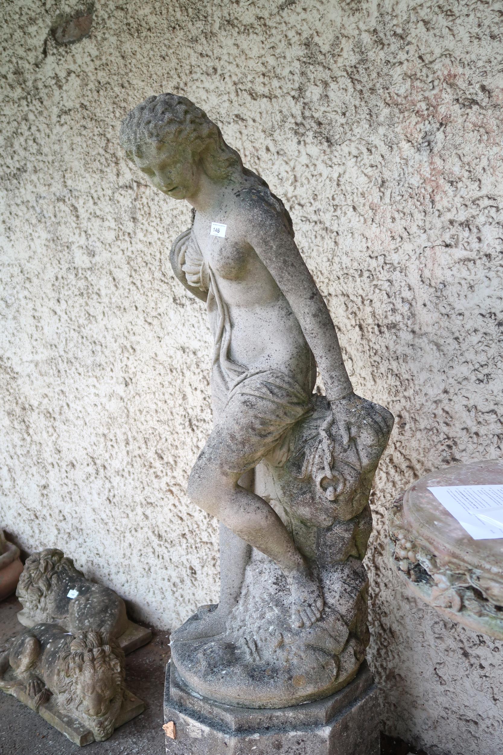 A 20th century reconstituted stone garden statue depicting classical bathing nude reclining on rocks - Image 3 of 3