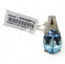 A 9ct gold blue topaz and diamond pendant, weight approx 2.6gms, (tag still in situ,) with a