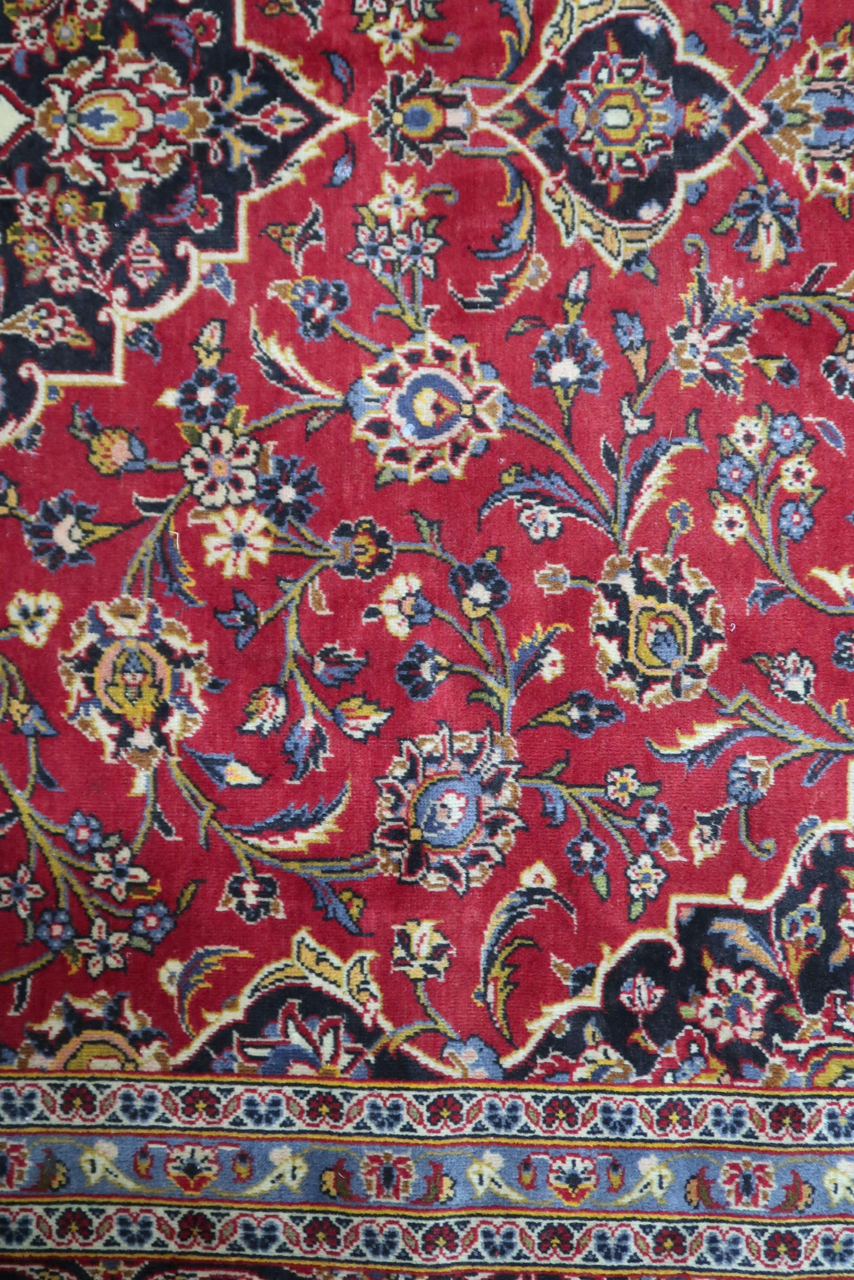 A RED GROUND KASHAN RUG  With dark blue and cream diamond central medallion and matching spandrels - Image 8 of 9