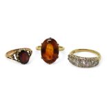 Three gem set rings, to include a 9ct gold citrine ring, size K1/2, a 9ct gold garnet ring, size