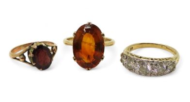 Three gem set rings, to include a 9ct gold citrine ring, size K1/2, a 9ct gold garnet ring, size