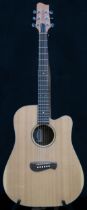 A Tacoma six string acoustic guitar with faux tortoise shell trim model DM AC serial number H3070030