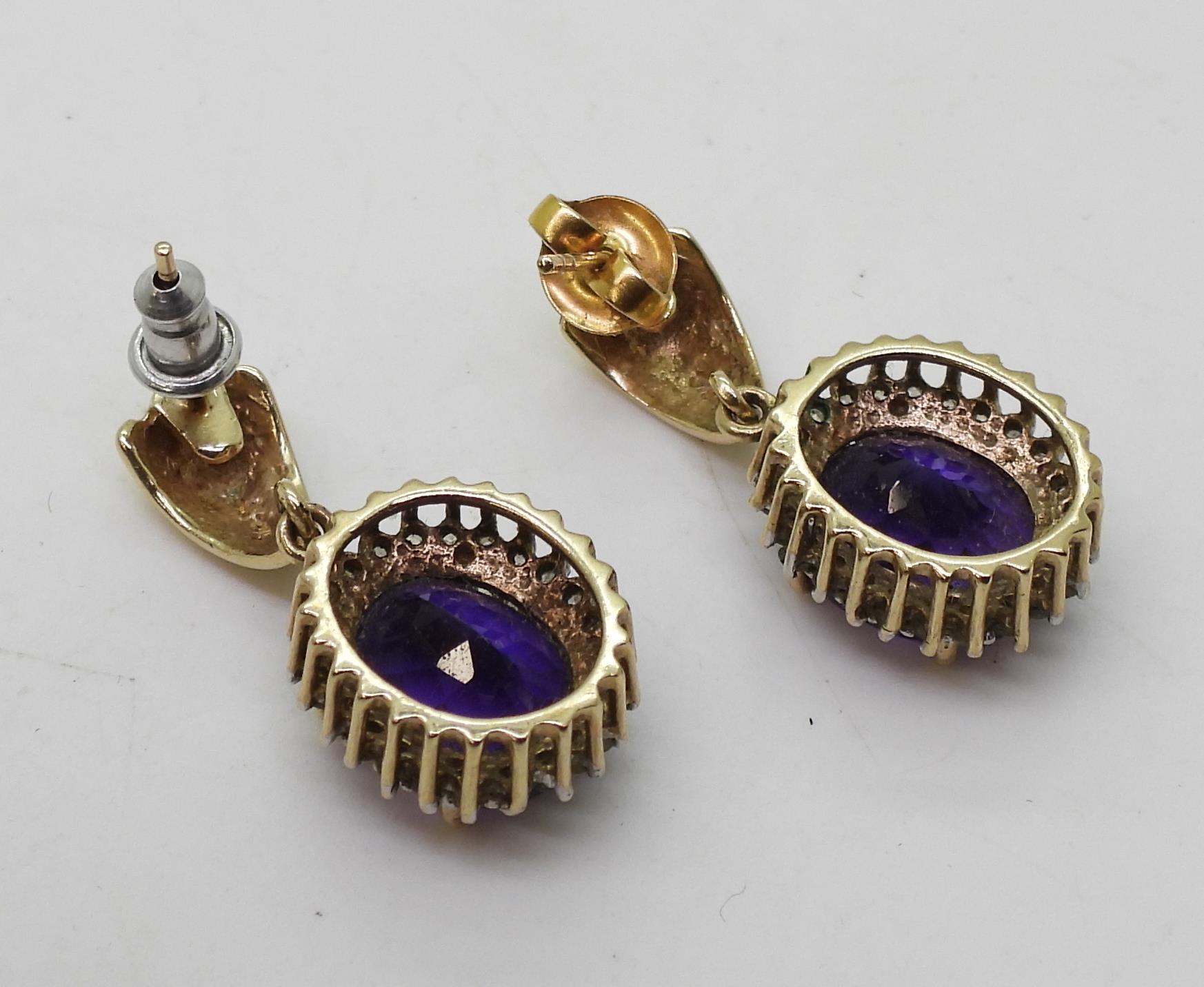 A pair of 9ct gold amethyst and clear gem set earrings, weight 6.1gms Condition Report:Available - Bild 4 aus 4