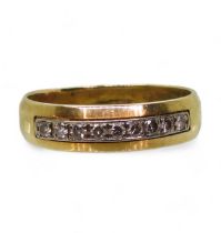 A 14k gold ring set with a band of diamonds with an estimated total of 0.20cts, size u, weight 4.