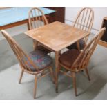 A mid 20th century Ercol elm and beech model 395 table with square top over railed lower tier on