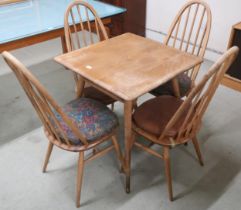 A mid 20th century Ercol elm and beech model 395 table with square top over railed lower tier on