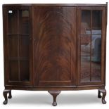 An early 20th century mahogany display cabinet with central cabinet door flanked by glazed doors